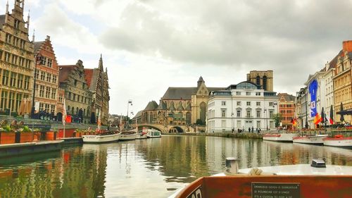 Boats in canal with buildings in background