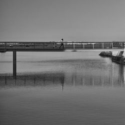 Pier over sea against clear sky