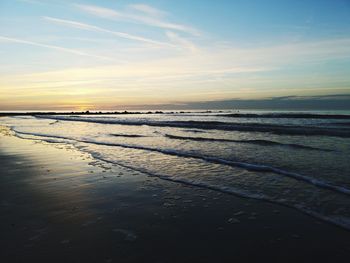 Scenic view of beach against sky during sunset