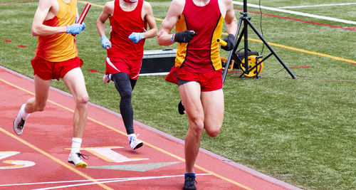 Low section of people running on grassland