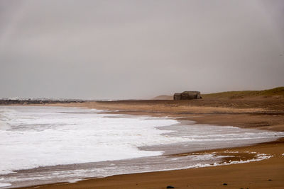 Scenic view of beach against clear sky