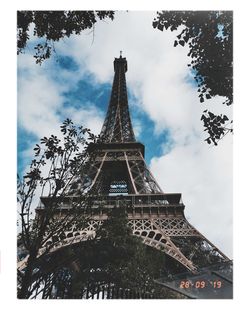 Low angle view of tower against cloudy sky