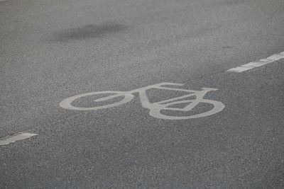 High angle view of sign on bicycle lane