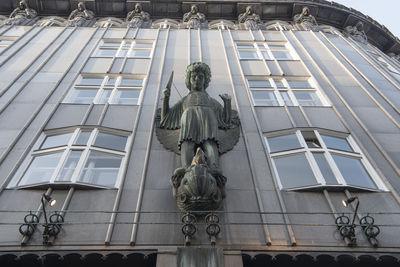 Low angle view of statue against historic building