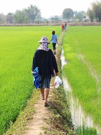 Rear view of woman walking on footpath