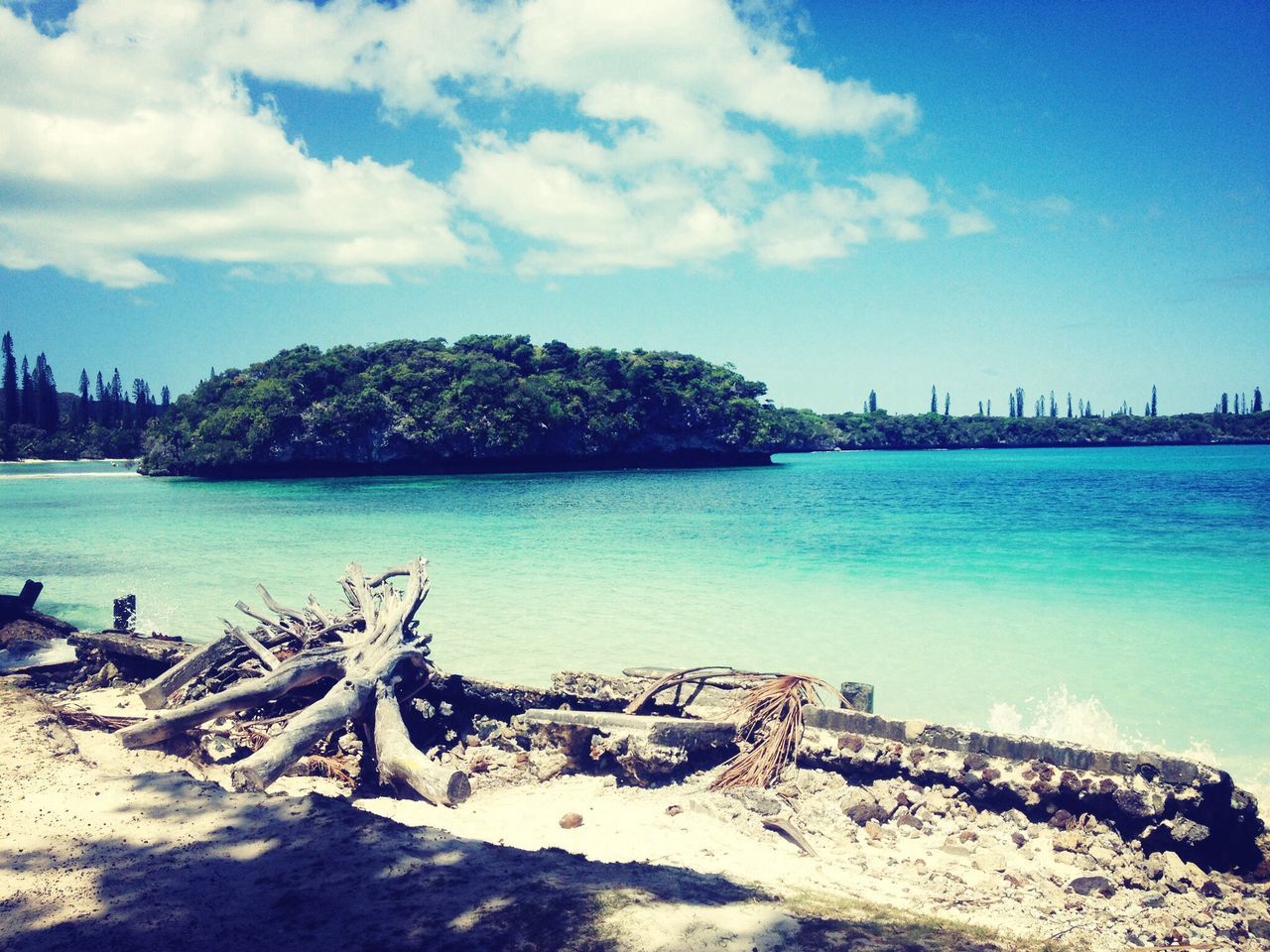 water, sky, sea, blue, beach, tranquility, cloud - sky, tranquil scene, scenics, nature, beauty in nature, built structure, shore, cloud, architecture, sand, day, mountain, building exterior, tree