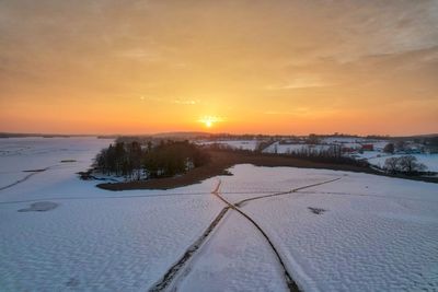 Drone photo of sunset over frozen lake