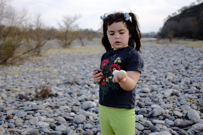 Full length of boy standing on rock