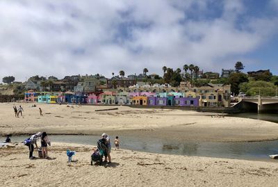 People on beach against sky