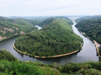 High angle view of river amidst trees against sky