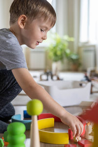 Boy playing with toys at home