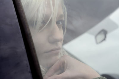 Close-up of woman seen through car glass window