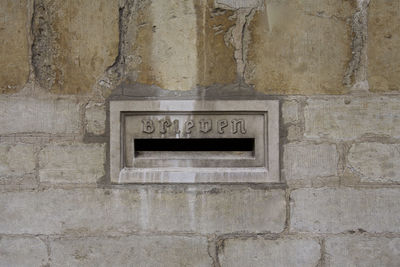 Close-up of text on brick wall