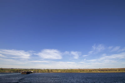 Scenic view of sea against blue sky