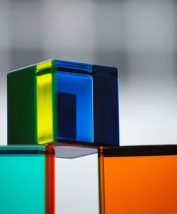 Close-up of multi colored glass on table