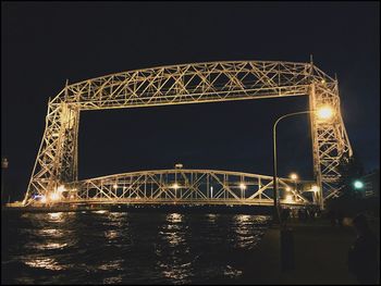 Illuminated suspension bridge at night