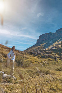 Young tourist walks on a path to the mountain. adventure travel, hiking concept.