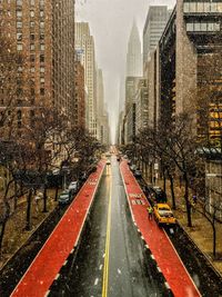 Street amidst buildings in city during winter