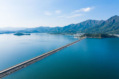 Scenic view of swimming pool by sea against sky