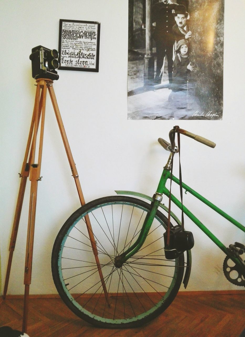 bicycle, transportation, mode of transport, communication, land vehicle, wall - building feature, stationary, indoors, retro styled, clock, parking, text, old-fashioned, no people, built structure, day, metal, parked, architecture, technology