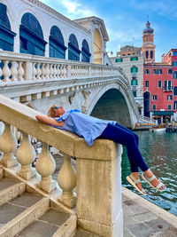 A beautiful girl lies in venice, next to the rialto bridge