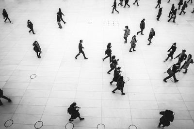 High angle view of people walking on floor