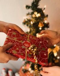 Close-up of hand holding christmas present