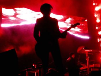 Man playing guitar in music concert