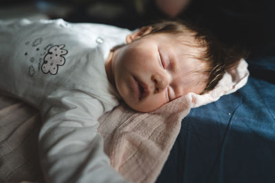 High angle view of woman sleeping on bed