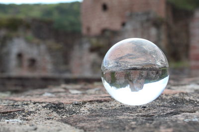 Close-up of crystal ball on glass