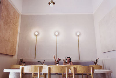 Men sitting on table against illuminated wall