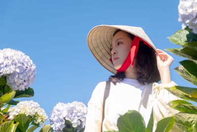 Woman wearing hat against sky