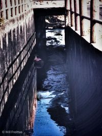 High angle view of canal amidst buildings