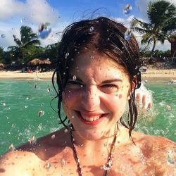Portrait of young woman in water