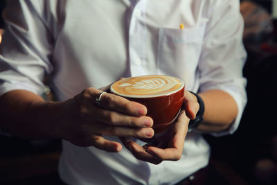 Bartender holding coffee cup