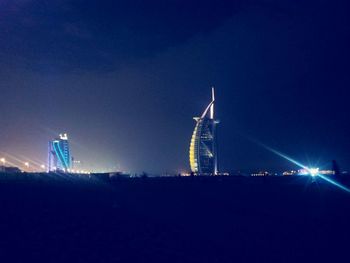 Low angle view of illuminated ferris wheel at night