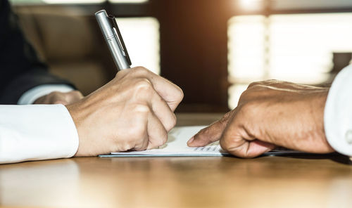 Close-up of man hand on table