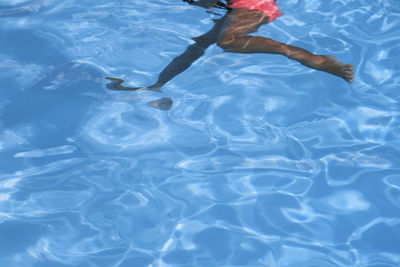 Low section of woman swimming in pool