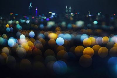 Defocused image of illuminated city at night