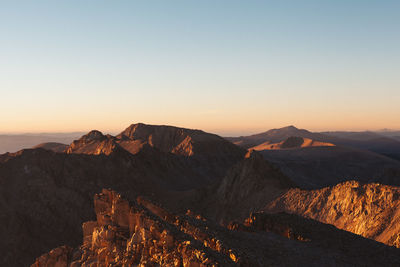 Scenic view of mountains against clear sky during sunset