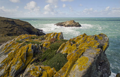 Rock formations by sea against sky