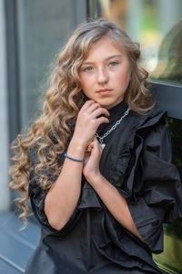 Portrait of beautiful young woman standing outdoors