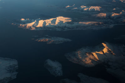 Aerial view of mountain range against sky during sunset