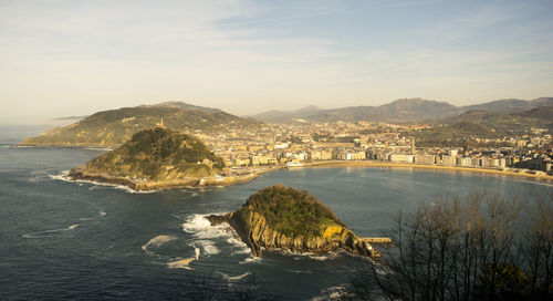 Scenic view of sea and city against sky