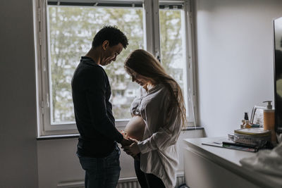 Pregnant woman with partner standing together