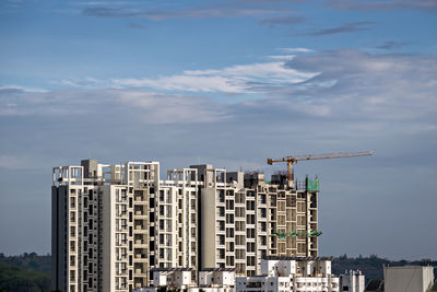 Twin, tall buildings under construction in pune, maharashtra, india.