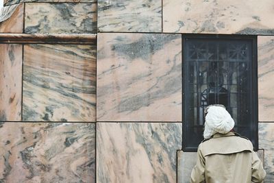 Rear view of people in front of building