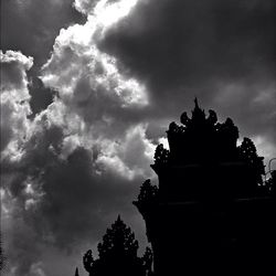 Low angle view of temple against cloudy sky