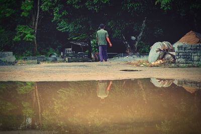 Reflection of man in puddle