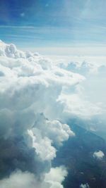 Scenic view of mountains against cloudy sky